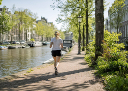 Hardloper langs een Amsterdamse gracht in de ochtend